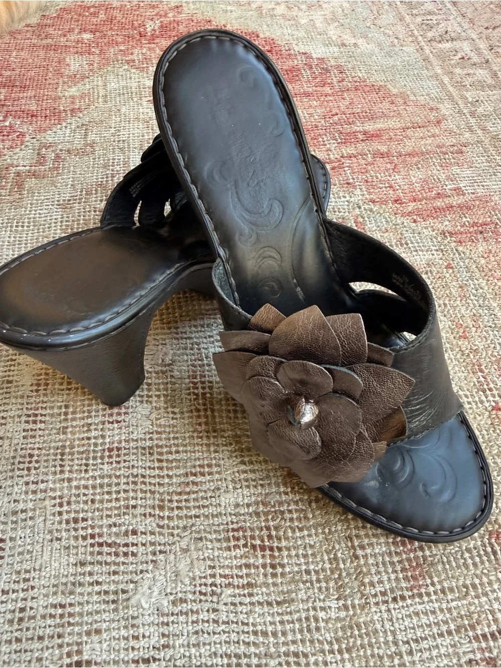 Born Black Heeled Mules with Metallic Bronze Floral Accent